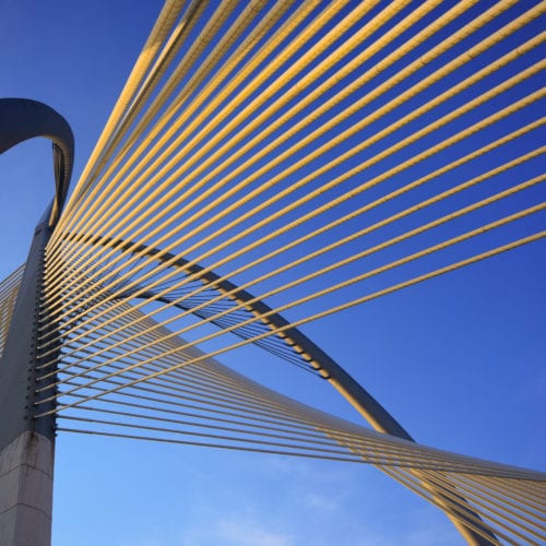 Architectural structure made of wire from perspective of the ground looking into the sky.